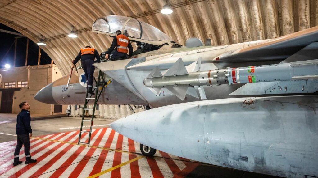 Crews work on an Israeli Air Force F-15 Eagle in a hangar, said to be following an interception mission of an Iranian drone and missile attack on Israel. Pic: Israel Defense Forces/Reuters