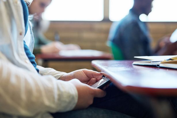 Children who are banned from bringing phones into class get better GCSEs, bombshell study finds