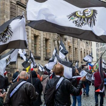 A 75-year-old woman, part of the so-called "United Patriots" terror group, appears in court accompanied by armed police in the Germany city of Koblenz.