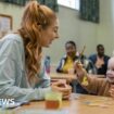 A mum and her young daughter playing together at a community centre