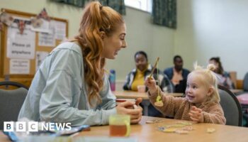 A mum and her young daughter playing together at a community centre