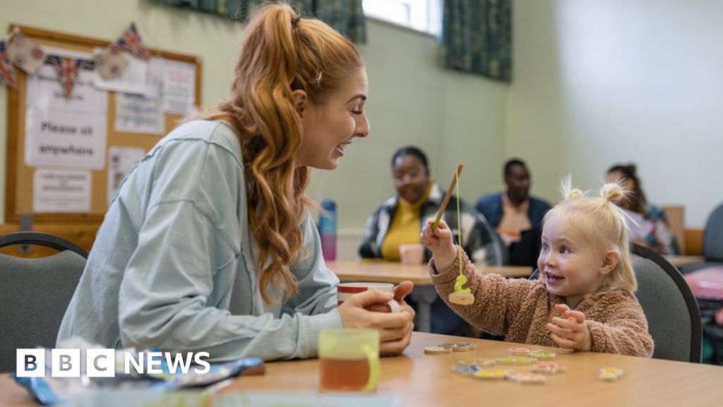 A mum and her young daughter playing together at a community centre