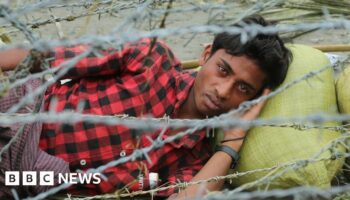 Rohingya refugees gather near the fence in the "no man's land" between Myanmar and Bangladesh border as seen from Maungdaw, Rakhine state, on June 29, 2018