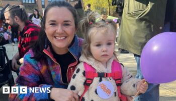 Parent Clare Sloane and daughter at childcare march in Belfast