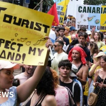 Protesters in Santa Cruz de Tenerife hold placards against mass tourism in Spain's Canary Islands. Photo: 20 April 2024