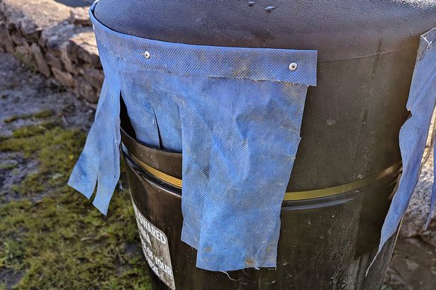 Town in 'disbelief' as council installs 'ridiculous' DIY curtains on rubbish bins