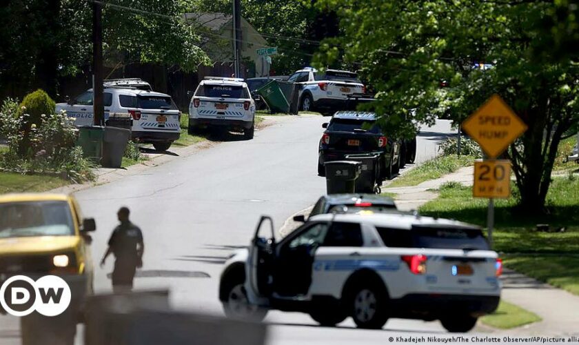 Law enforcement officers congregate outside an armored vehicle at the Aldi on New Bern Avenue in Raleigh after five people were shot and killed in the Hedingham Neighborhood and Nuese River Trail area in Raleigh, N.C., Thursday, Oct. 13, 2022.