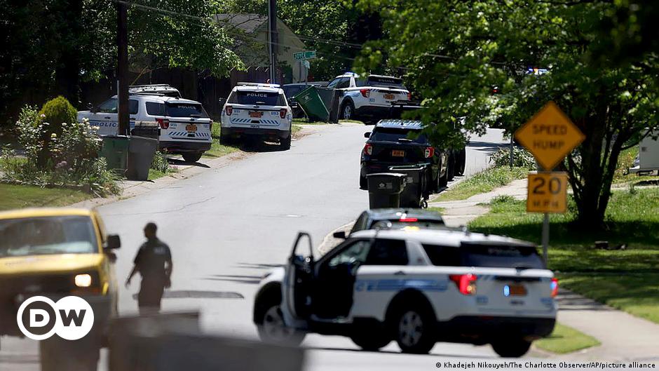 Law enforcement officers congregate outside an armored vehicle at the Aldi on New Bern Avenue in Raleigh after five people were shot and killed in the Hedingham Neighborhood and Nuese River Trail area in Raleigh, N.C., Thursday, Oct. 13, 2022.