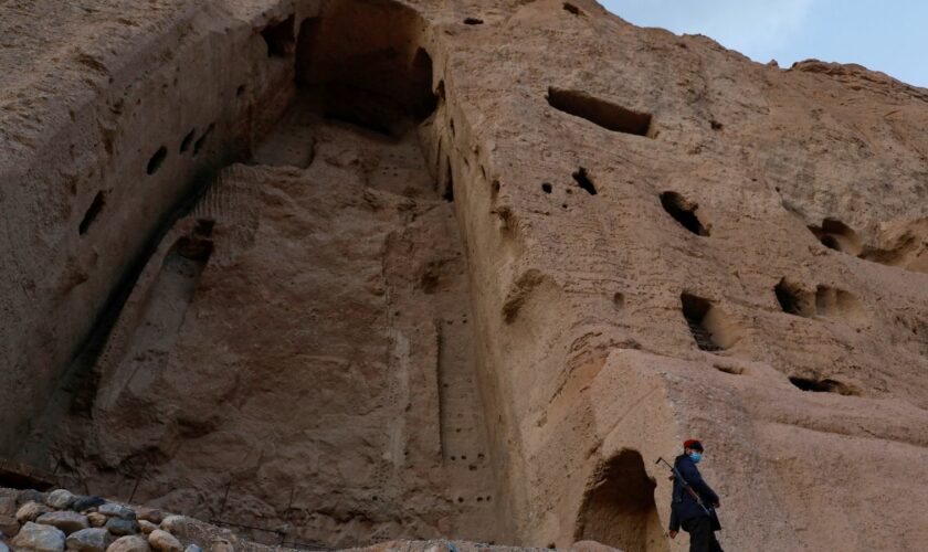 A Taliban soldier stands guard in front of the ruins of a 1500-year-old Buddha statue in Bamiyan. File pic: Reuters