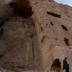 A Taliban soldier stands guard in front of the ruins of a 1500-year-old Buddha statue in Bamiyan. File pic: Reuters