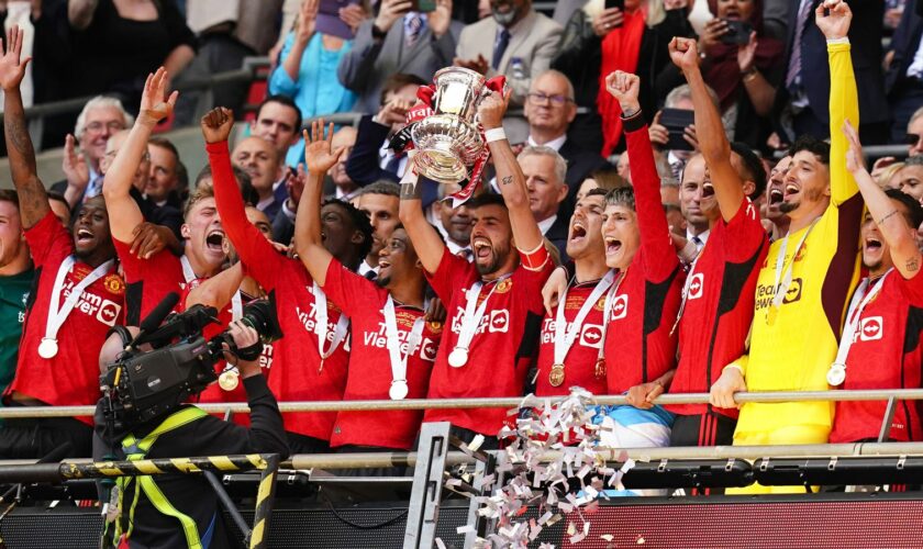 Manchester United's Bruno Fernandes lifts the FA Cup after the side won the Wembley final. Pic: PA