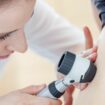 Dermatologist Inspecting Patient Skin Moles stock photo. Key words, melanoma, skin cancer. Pic: CasarsaGuru/iStock