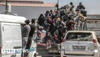 Palestinians cram on to a van after deciding to flee Rafah, as Israeli forces continue a ground operation in the southern Gaza city (8 May 2024)