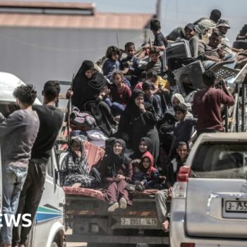 Palestinians cram on to a van after deciding to flee Rafah, as Israeli forces continue a ground operation in the southern Gaza city (8 May 2024)