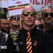 Protesters holding placards with messages related to the NHS infected blood scandal