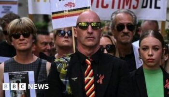 Protesters holding placards with messages related to the NHS infected blood scandal