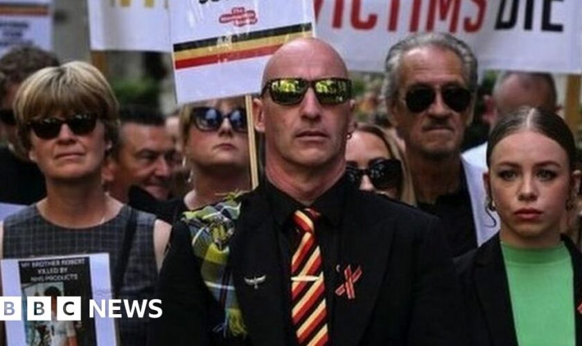 Protesters holding placards with messages related to the NHS infected blood scandal