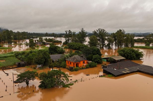 Major storms in Brazil burst hydroelectric dam as people left stranded on rooftops amid flooding