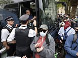 Masked protesters pop tyres and hurl Lime bikes under the path of coach trying to take migrants to Bibby Stockholm barge after forming a human chain outside hotel