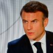 Le président de la République Emmanuel Macron photographié sur un écran de télévision lors de son entretien sur TF1 et France 2 le 14 mars 2024, à Paris