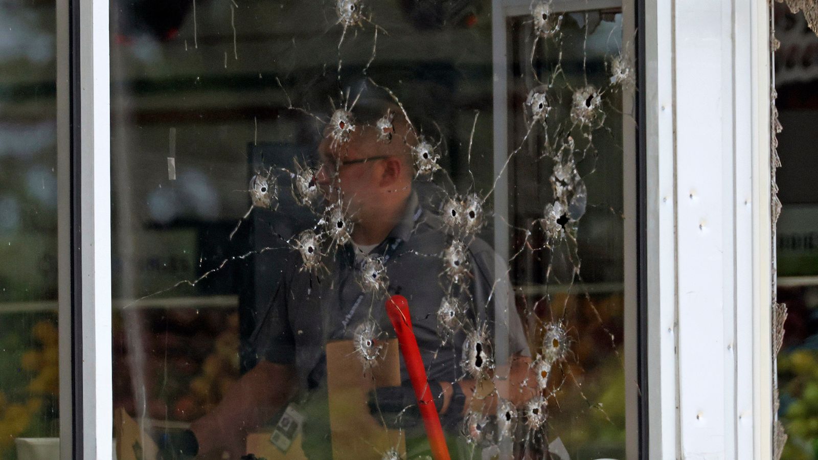 Damage to the supermarket's front window after the shooting. Pic: AP