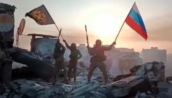 FILE - In this image from video provided by Prigozhin Press Service on Saturday, May 20, 2023, Yevgeny Prigozhin's Wagner Group military company members wave a Russian national and Wagner flag atop a damaged building in Bakhmut, Ukraine. Yevgeny Prigozhin's armed revolt against Russia's military leadership posed the greatest challenge to Vladimir Putin's authorities in his 23-year rule. (Prigozhin Press Service via AP, File)