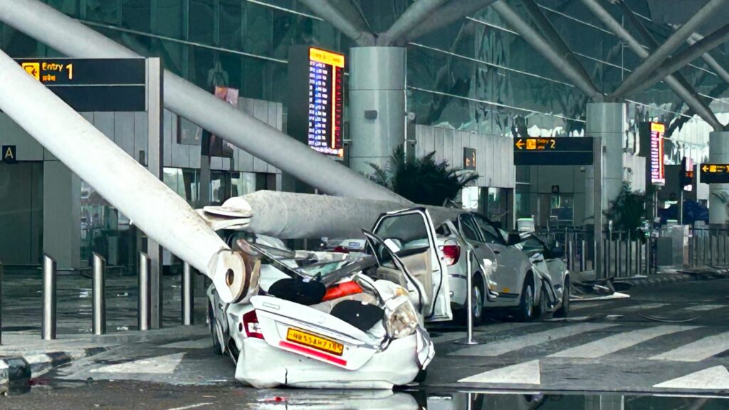 Parked vehicles are damaged by the collapse of a departure terminal canopy at New Delhi's Indira Gandhi International Airport following heavy pre-monsoon rains in New Delhi, India, Friday, June 28, 2024. (AP Photo)