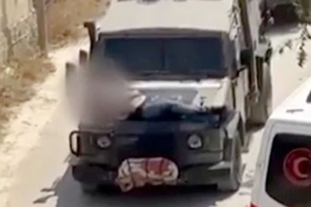Israeli soldiers caught strapping wounded Palestinian to jeep bonnet