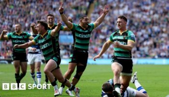 Northampton players raise their arms in celebration after the final whistle is blown