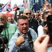 Tommy Robinson leads 'football hooligan' march in London demanding resignation of Met Police chief Mark Rowley as thousands of officers take to the streets