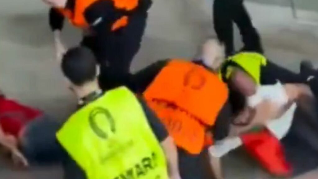 Stewards appeared to punch and kick a football fan