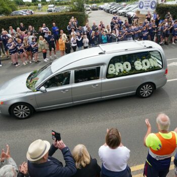 The funeral cortege passes through Featherstone town centre. Pic: PA