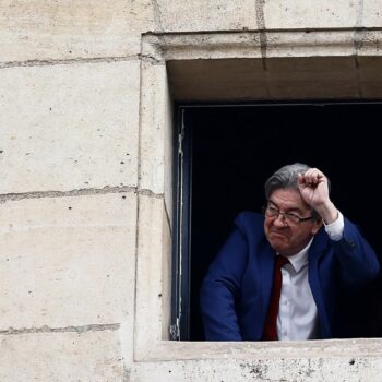 Jean-Luc Melenchon, leader of French far-left opposition party La France Insoumise (France Unbowed - LFI), and member of the alliance of left-wing parties, called the "Nouveau Front Populaire" (New Popular Front - NFP), gestures after partial results in the second round of the early French parliamentary elections, at Place Stalingrad in Paris, France, July 7, 2024. REUTERS/Yara Nardi