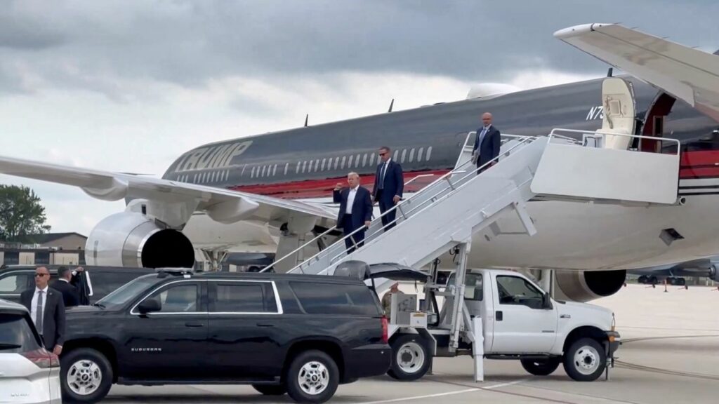 Republican presidential candidate and former U.S. President Donald Trump gestures as he arrives at Milwaukee Mitchell International Airport a day after he survived an assassination attempt at a rally in Butler, Pennsylvania, in Milwaukee, Wisconsin, U.S., July 14, 2024 in this screengrab obtained from a social media video. Dan Scavino Jr. via X/via REUTERS THIS IMAGE HAS BEEN SUPPLIED BY A THIRD PARTY. MANDATORY CREDIT. NO RESALES. NO ARCHIVES.