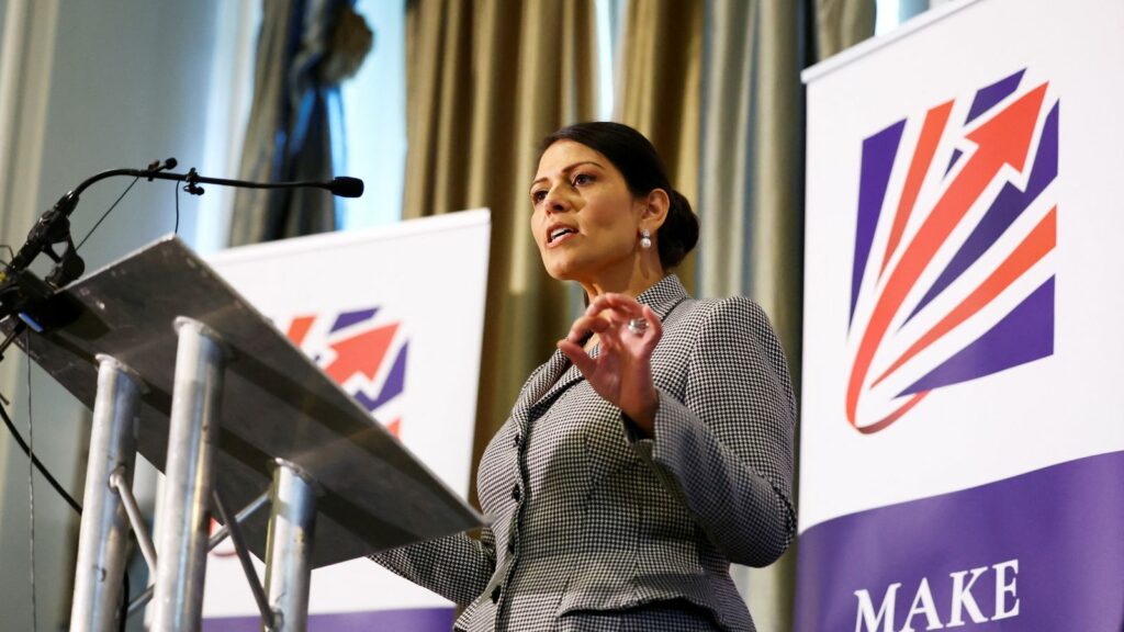 Priti Patel speaks on stage at the Britain's Conservative Party's annual conference in Manchester