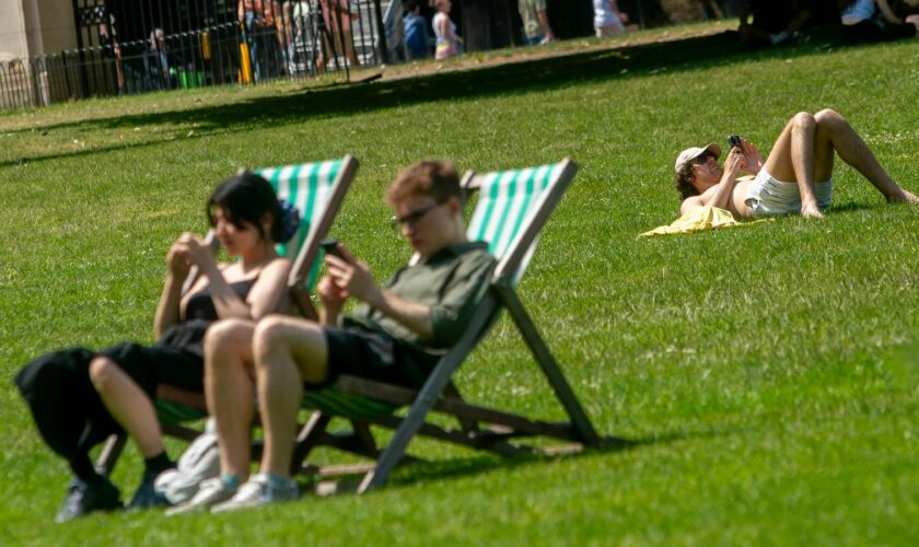 Sunbathers in Green Park, London. File pic: PA