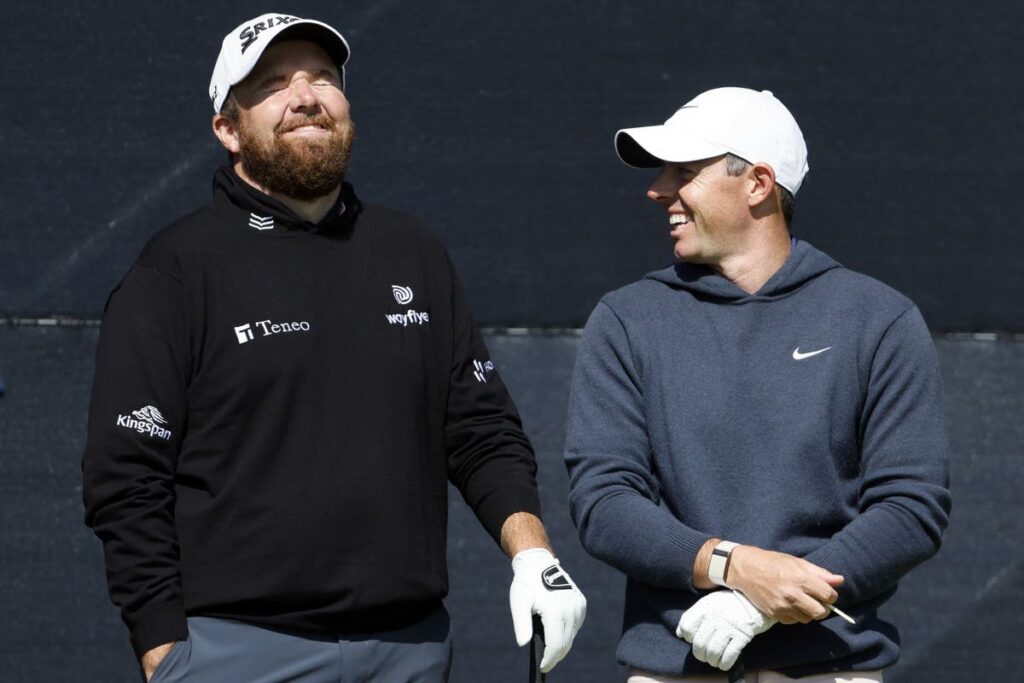 Open day three: Rory McIlroy supporting leader Shane Lowry after missing the cut