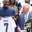 King Charles and Idris Elba show their support for the Three Lions as they beam in photos holding England shirts - after royal's playful plea for team to secure a drama-free victory in the Euros final