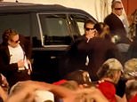 Moment Secret Service agent struggles to holster her weapon in chaotic scenes after Trump shooting - as questions grow over ex-President's security with Republicans claiming they made 'repeated requests for stronger protection'