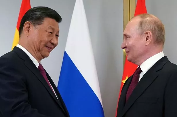 Smiling Putin meets with 'old pal' President Xi in power move against West