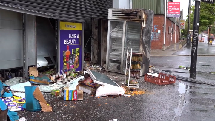 Supermarket manager surveys destroyed store after riots and fires in Belfast