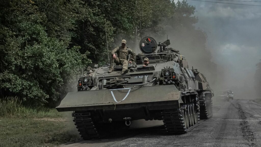 Ukrainian servicemen ride a military vehicle near the Russian border. Pic: Reuters