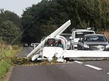 Heart-stopping moment light aircraft pilot and passenger crash onto busy road after glider 'stalled and nose dived' - as pair miraculously escape uninjured