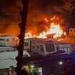 Massive blaze breaks out at caravan storage yard in Oldham with plumes of thick black smoke seen for miles