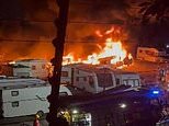 Massive blaze breaks out at caravan storage yard in Oldham with plumes of thick black smoke seen for miles