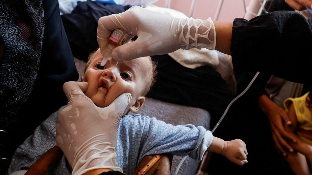 A Palestinian child is vaccinated against polio. Pic: Reuters