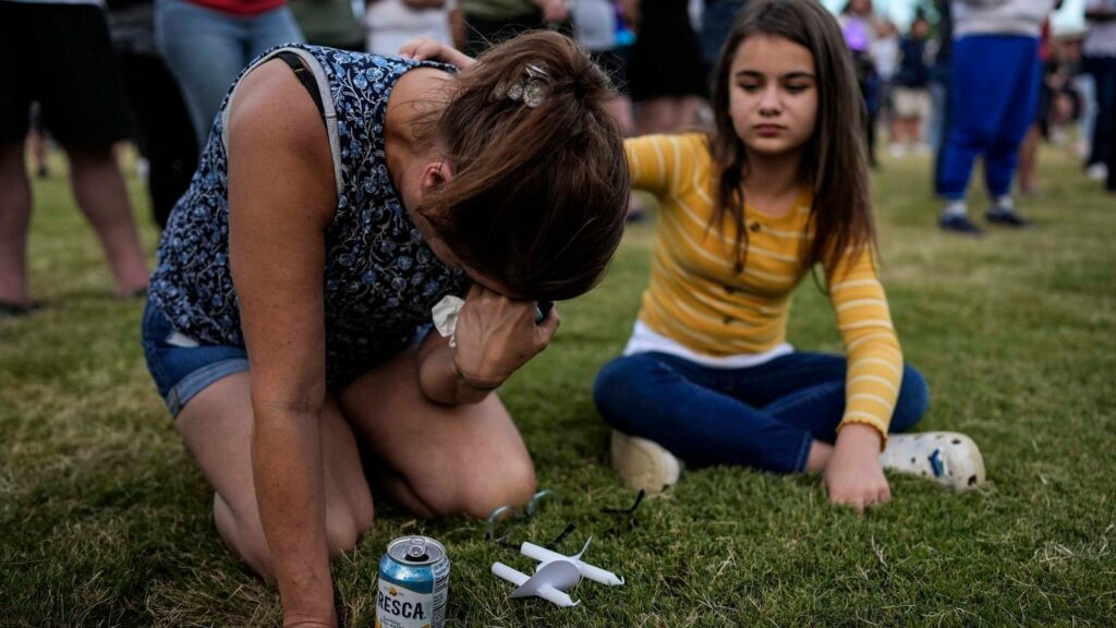 Brandy Rickaba and her daughter Emilie during a candlelight vigil for the victims of the school shooting. Pic: AP