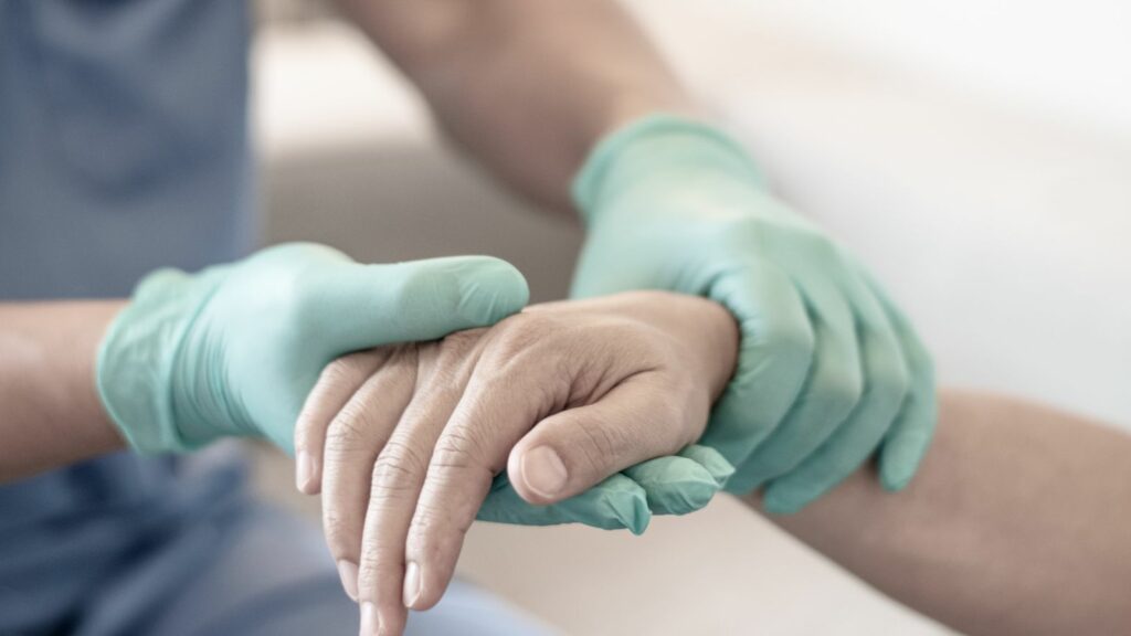 Surgeon, physician performs surgical operations, anesthetist or anesthesiologist holding patient's hand ffor checking state of mand or support in ER room, Medical healthcare concept