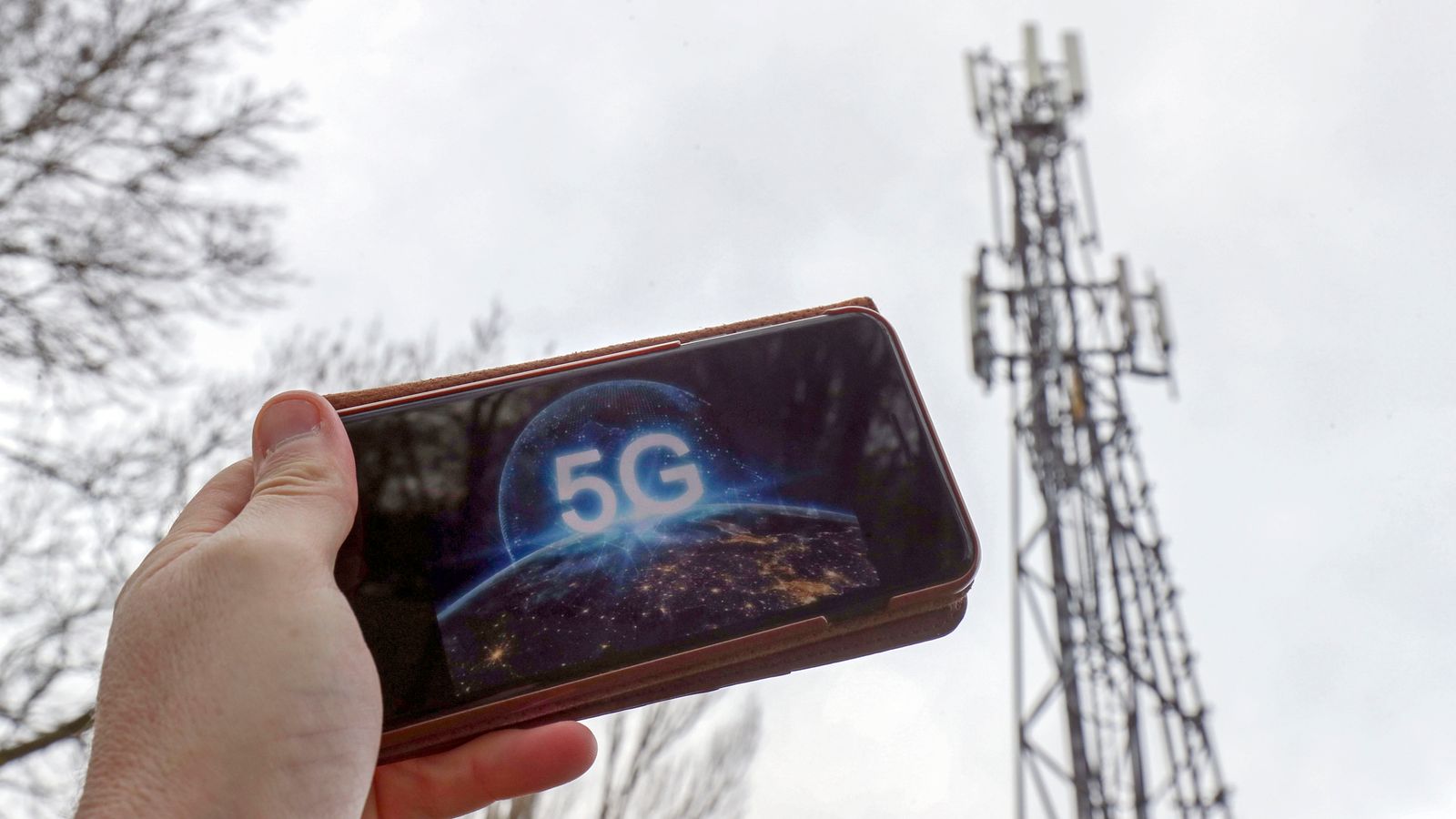 A 5G phone next to a telecoms mast near Wokingham, Berkshire. Pic: PA