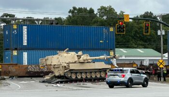 Train collides with military mobile artillery vehicle being hauled on a semi-truck